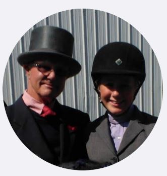 Tim Wright and daugter in hats by the barn. 